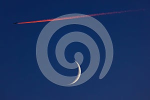 Blue sky with moon and flying airplane