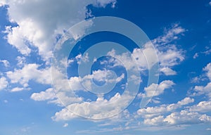 Blue sky nature background with fluffy white clouds