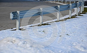 Blue sky and nice frosty weather and snow. bend paved with concrete interlocking paving. galvanized iron used for safety barrier.