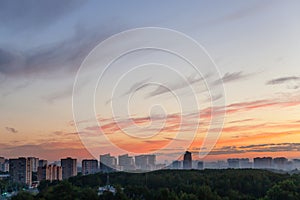 Blue sky with orange sunlight over city