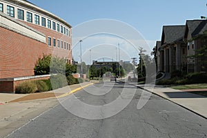 Blue sky over the asphalt road surrounded by private houses