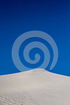 Blue Sky Over Crest of White Dune