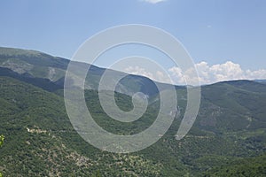 Blue sky over a green mountain