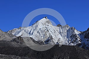 Blue sky over snow capped mount Kongma Tse