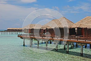 Blue sky overwater Bungalow with Zigzag Design at a tropical resort island, Maldives