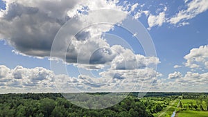 Blue sky panorama with clouds over tops of green trees. Blue sky and white cloud soft. White clouds background