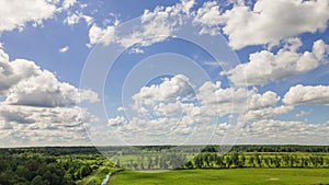 Blue sky panorama with clouds over tops of green trees. Blue sky and white cloud soft. White clouds background