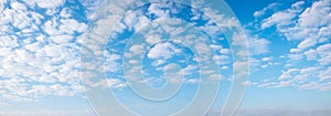 blue sky panorama with fleecy white clouds background