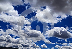 Blue sky with peacefull cotton clouds in Qinghai Tibet Plateau photo