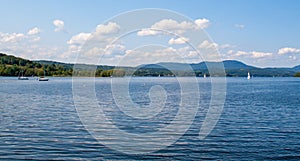 Blue sky and puffy white clouds over calm Lake Memphremagog