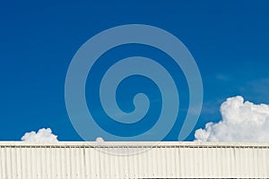 Blue sky and roof of warehouse