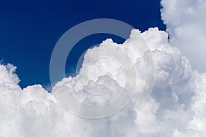 Blue sky with some white puffy clouds.