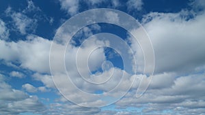 Blue sky with stratocumulus clouds and sun. Beautiful sky with clouds background. Timelapse.