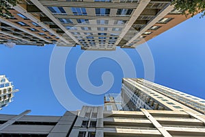 Blue sky on a sunny day with exterior view of apartments and parking garage