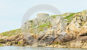 Blue sky and sunny day with Fort, Martello tower, Saint Begnet`s Church on Dalkey Island, County Dublin, Ireland.