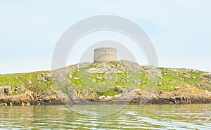 Blue sky and sunny day with Fort, Martello tower, Saint Begnet`s Church on Dalkey Island, County Dublin, Ireland.