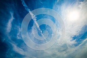 Blue sky and trail of jet plane. Natural background.