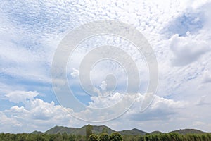 Blue sky with trees, clouds and mountains, sky background image