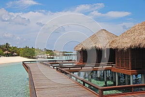 Blue sky turquoise water dream vacation in Traditional Wooden Overwater Bungalow at a tropical resort island, Maldives