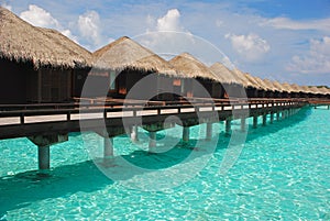 Blue sky turquoise water Getaway Island Holiday on Overwater Bungalow at a tropical resort island, Maldives