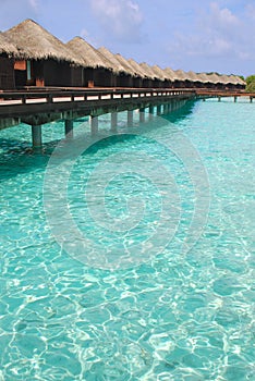 Blue sky turquoise water Getaway Island Holiday on Overwater Bungalow at a tropical resort island, Maldives