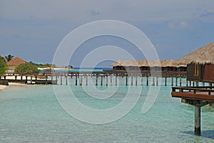 Blue sky turquoise water overwater Bungalow Vacation at a tropical resort island, Maldives