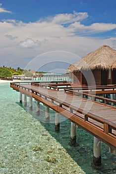 Blue sky turquoise water overwater Bungalow for your next Island Vacation at a tropical resort island, Maldives