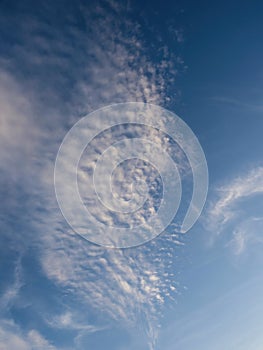 Blue sky with unusual abstract white clouds.