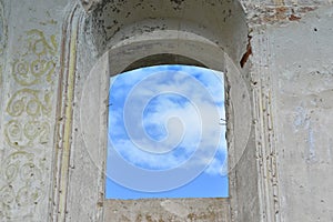the blue sky is visible through the thick walls of the fortress of the monastery. the concept of freedom unfreedom