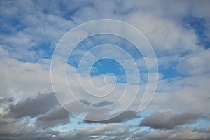 The blue sky is visible through a veil of gray clouds Atmosphere