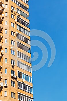 Blue sky and wall of brick multistoried house photo