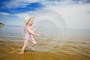 Blue sky, water and running child