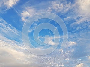 Blue sky with whispy white cloud formation
