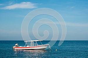 Blue sky and a white boat in a blue Caribbean sea