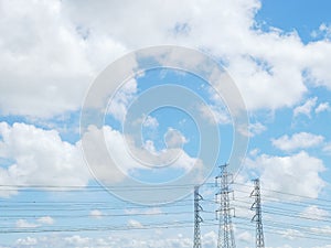 Blue sky and white cloud with high voltage transmission towers and power line the electricity infrastructure
