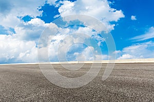 Blue sky white clouds and asphalt road