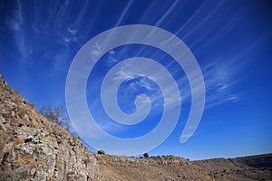 Blue sky with white clouds. Fan clouds formed