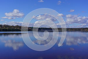 Blue Sky and White Clouds Reflecting on Eccup Reservoir, Leeds, West Yorkshire, UK.