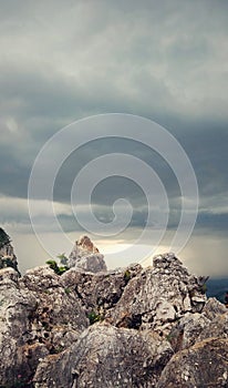 Blue sky white coulds sunset between the rocks