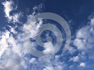 Blue sky and white feathery clouds. Copy space and background