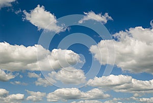 Blue sky with white fluffy clouds in the spring or summer day