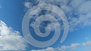 Blue sky with white stratocumulus clouds. Sunny background, blue sky with white clouds. Timelapse.