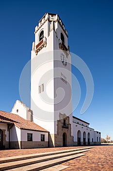 Blue sky and white stucco train depot clock tower