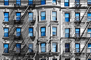 Blue sky in the windows of a black and white building New York City