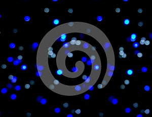 Blue small circles abstract blurred and bokeh of LED party light bubs reflection lighting on black background.