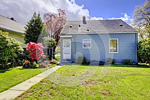 Blue small house with spring landscape from backyard. photo