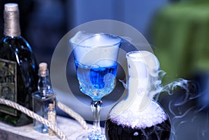 Blue smoke bottle containing witches brew, mana replenishment