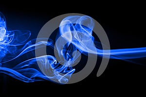 Blue smoke movement abstract on black background, darkness concept