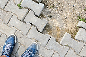 Blue Sneakers on Concrete Block Pavement