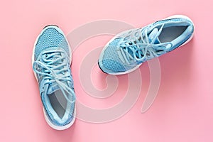 Blue sneakers isolated on a pink background